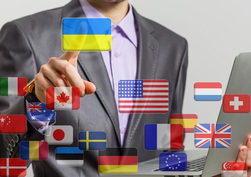 Hand pushing on a touch screen interface, choosing Ukraine. flags of the world.