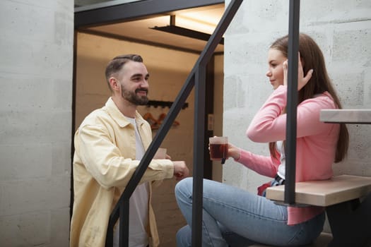 Beautiful woman sitting on the staircase at hotel room talking to her boyfriend