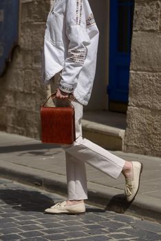 close-up photo of orange leather bag . street photo