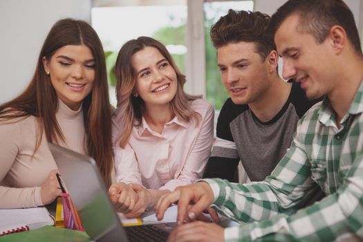 Friendship, youth concept. Lovely young cheerful female student smiling joyfully at her friends, enjoying studying together. University students preparing for an exam