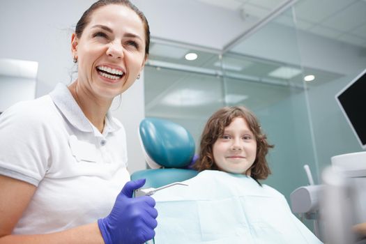 Dentist laughing working with child