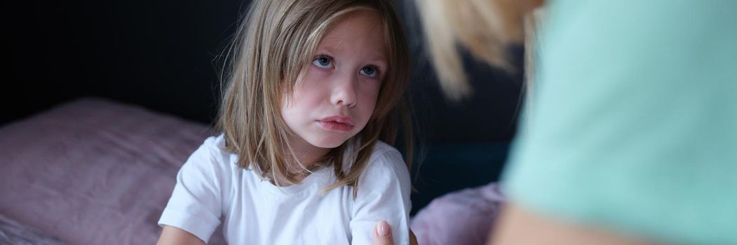 Mom calms a little scared girl on the bed, close-up, Children's nightmare, child's emotional health, insomnia anxiety