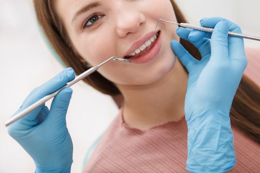 Cropped close up of a woman getting her teeth checked by professional dentist