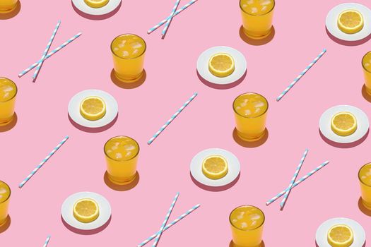 Summer pattern on a bright pink pastel background sunlight fruity orange cocktail plates and tubes. Minimal trend summer concept.