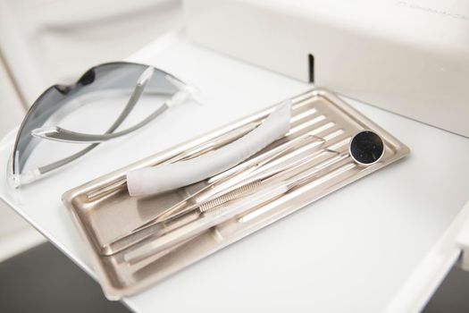 Sterile dental tools and protective eyeglasses at dentists office