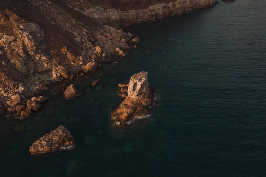 Aerial top evening view drone above Adriatic sea in Montenegro. panoramic sunny marine mountain sunset. summer nature wallpaper. dark calm water rock. mountains coast seaside. Amazing outdoors view
