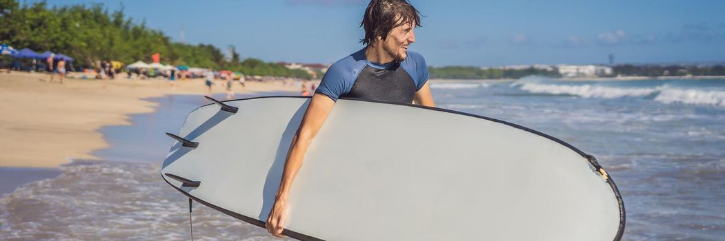 Surfer with his surfboard running to the waves. BANNER, LONG FORMAT