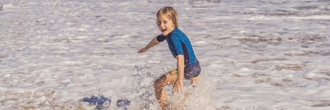 Cute little boy having fun on tropical beach during summer vacation. BANNER, LONG FORMAT