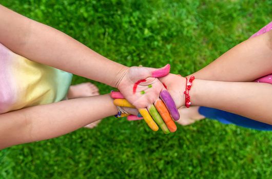 Hands of a child with a drawn emoticon. Selective focus.