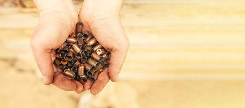Bullet casings after a shot from military cartridges in the hands of a military soldier.