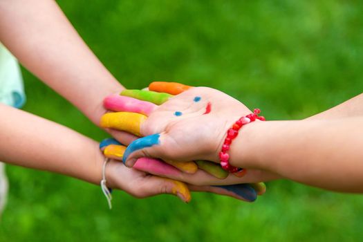 Hands of a child with a drawn emoticon. Selective focus.