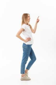 Lifestyle Concept: Portrait woman pointing or pushing something with index finger. Beautiful casual young woman isolated on white background in full length standing in profile