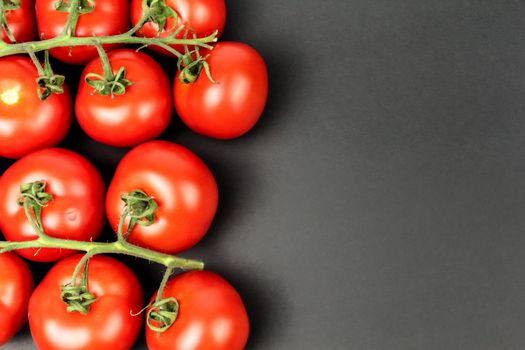 Red tomatoes on white plate with water drops