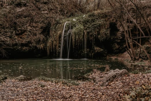 small pond lake river green. summer-autumn after sunset fallen orange leaves mist. waterfall Burbun in village Lysets Dunaivtsi Khmelnytskyi Ukraine