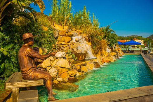 MARMARIS, MUGLA, TURKEY: Beautiful Artificial waterfalls in the center of Marmaris with turquoise water on a sunny day.