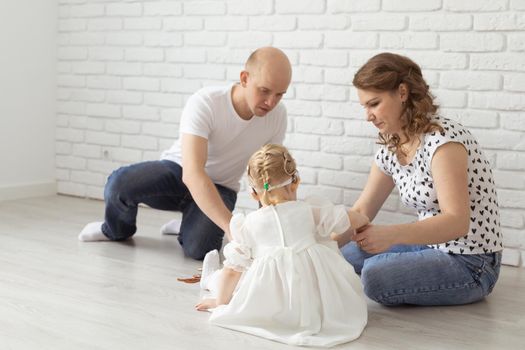 Child girl with cochlear implant plays at home. Hear impairment and diversity and hearing aid