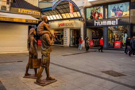 MARMARIS, MUGLA, TURKEY: Sculptures of a family who go shopping on the shring on the street in Marmaris.