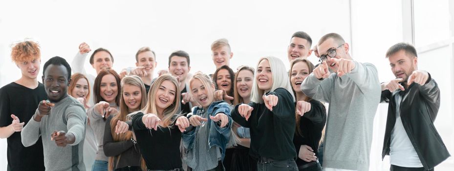 group of confident young people pointing at you. isolated on white background