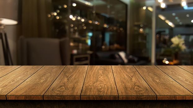 Wood table in blurry background of modern restaurant room or coffee shop with empty copy space on the table for product display mockup. Interior restaurant counter design concept.