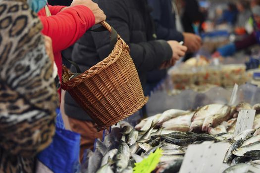 Customer With a basket near counter with herring
