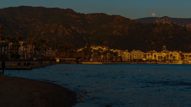 MARMARIS, MUGLA, TURKEY: Landscape with a view of the old town, Fortress and ships in Marmaris at sunset.