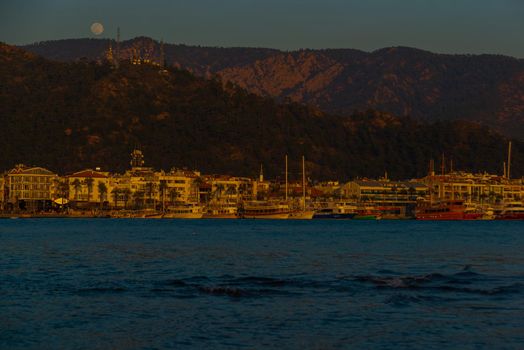 MARMARIS, MUGLA, TURKEY: Landscape with a view of the old town, Fortress and ships in Marmaris at sunset.