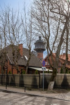 View of old European houses with tiled roofs and a high water tower in the city center in Zelenogradsk, Kaliningrad region, Russia, near the Baltic sea.