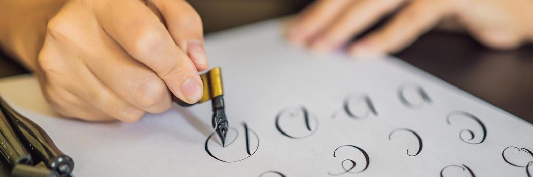 BANNER, LONG FORMAT Calligrapher Young Woman writes phrase on white paper. Inscribing ornamental decorated letters. Calligraphy, graphic design, lettering, handwriting, creation concept.