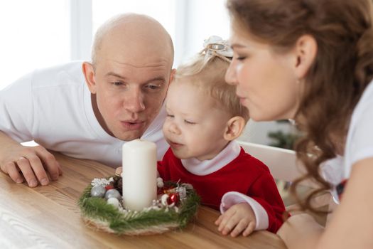 Baby child with hearing aid and cochlear implant having fun with parents in christmas room. Deaf and health