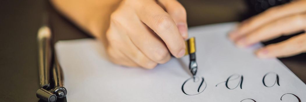 BANNER, LONG FORMAT Calligrapher Young Woman writes phrase on white paper. Inscribing ornamental decorated letters. Calligraphy, graphic design, lettering, handwriting, creation concept.