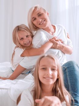 portrait of a mother with two small daughters . isolated on white background