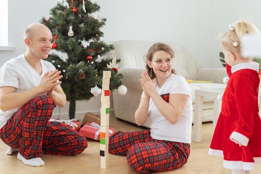 Toddler child with cochlear implant decorating christmas tree deafness and innovating medical technologies for hearing aid