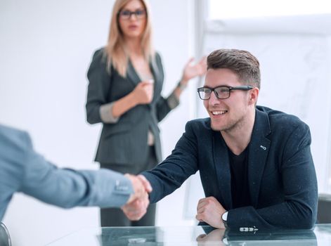 close up. business man shaking hands with his business partner. concept of cooperation