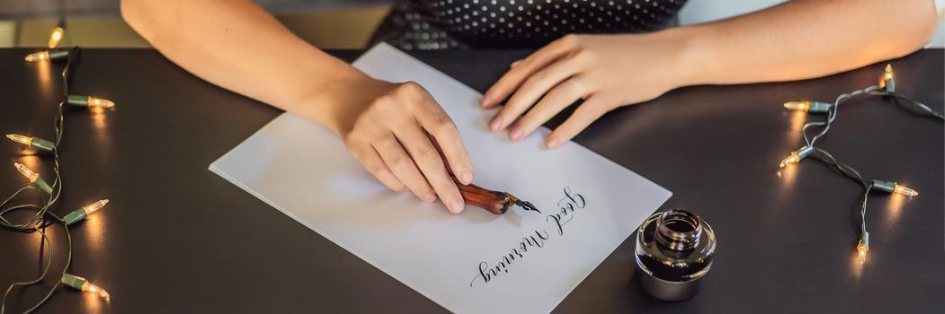 BANNER, LONG FORMAT Good morning. Calligrapher Young Woman writes phrase on white paper. Inscribing ornamental decorated letters. Calligraphy, graphic design, lettering, handwriting, creation concept.