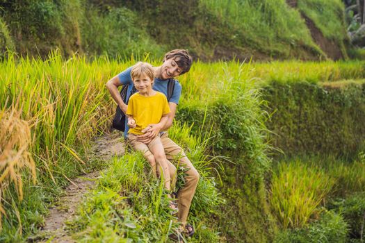 Dad and son travelers on Beautiful Rice Terraces against the background of famous volcanoes in Bali, Indonesia Traveling with children concept.