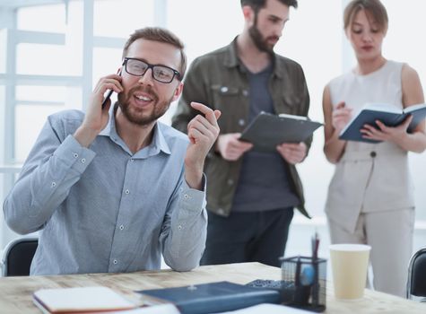 business man talking to a client on a smartphone. people and technology