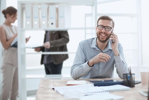 business man talking to a client on a smartphone. people and technology