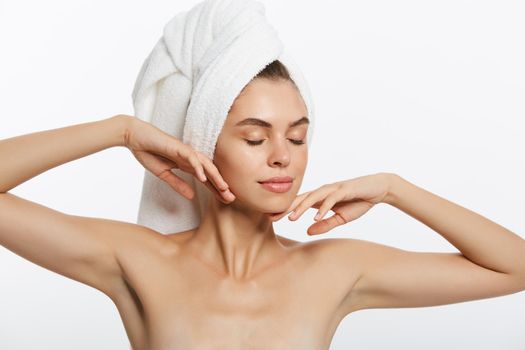 Tiredness, boredom concept. Sleepy woman placing hand on mouth yawning while holding towel on head