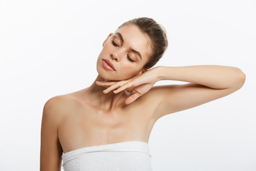 Beautiful Caucasian woman with towel against a white background