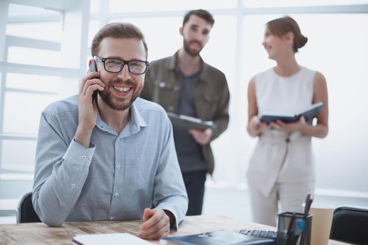 business man talking to a client on a smartphone. people and technology