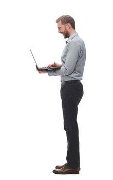 in full growth. smiling young businessman with laptop. isolated on white background