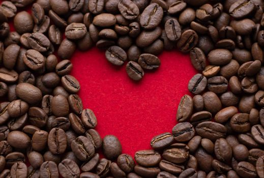 Creative concept photo of heart made of coffee on isolated background.