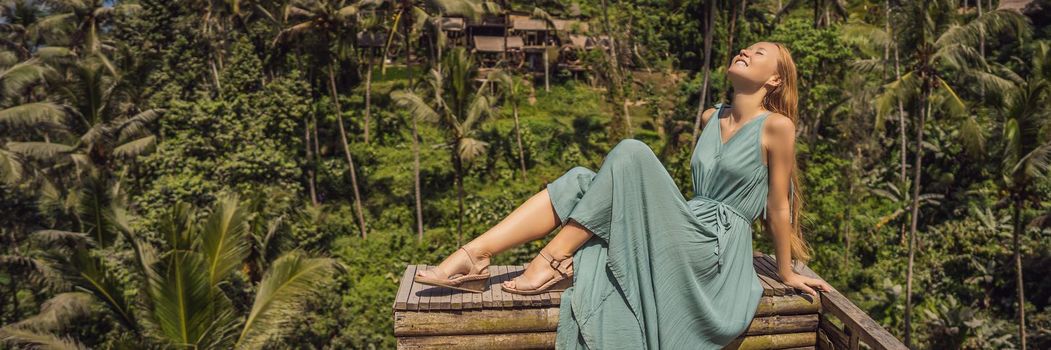 BANNER, LONG FORMAT Beautiful young woman walk at typical Asian hillside with rice farming, mountain shape green cascade rice field terraces paddies. Ubud, Bali, Indonesia. Bali travel concept.