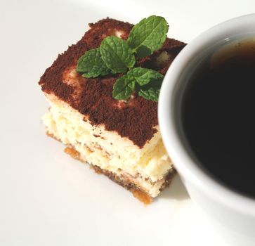 Cup of coffee and piece of cake tiramisu