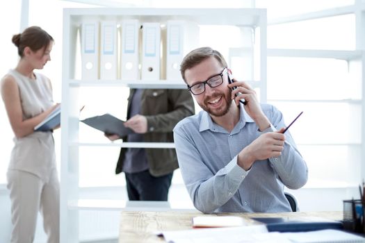 business man talking to a client on a smartphone. people and technology