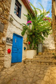 MARMARIS, MUGLA, TURKEY: Ornate street with old houses in the historical center in Marmaris. Narrow streets with stairs among the houses with white brick, green plants and flowers.