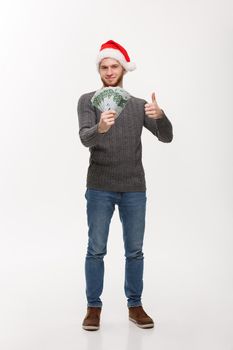 Holiday Concept - young beard man holding money in front over white background