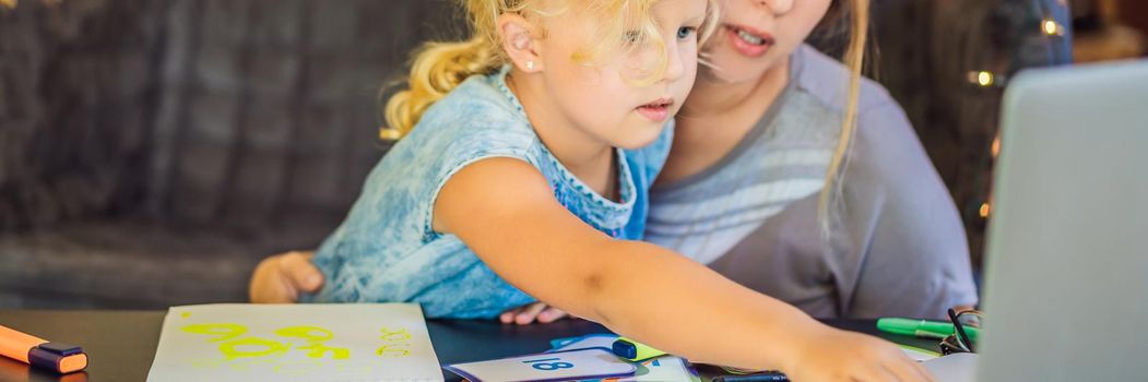 A teacher, a tutor for home schooling and a teacher at the table. Or mom and daughter. Homeschooling. BANNER, LONG FORMAT