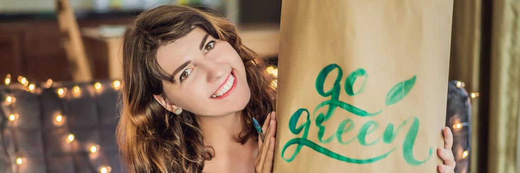 Go green. Calligrapher Young Woman writes phrase on white paper. Inscribing ornamental decorated letters. Calligraphy, graphic design, lettering, handwriting, creation concept. BANNER, LONG FORMAT