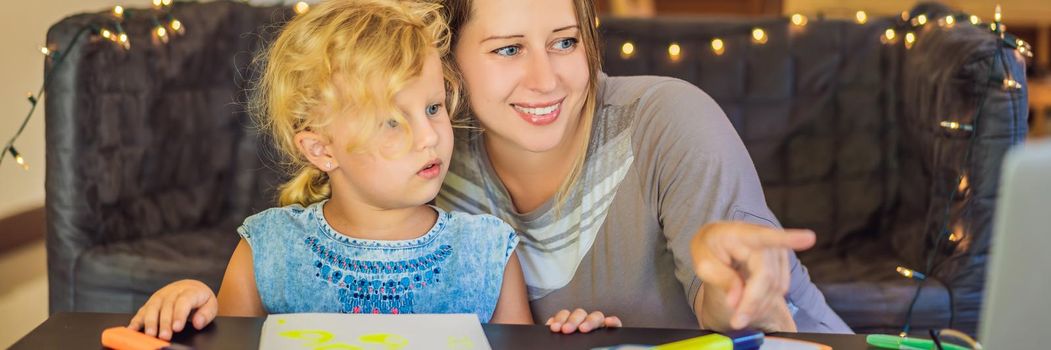 A teacher, a tutor for home schooling and a teacher at the table. Or mom and daughter. Homeschooling. BANNER, LONG FORMAT